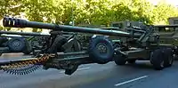 A howitzer with folded trails and barrel rotated for transport.