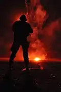 Third Phase A trainee is illuminated by a flare during a live-fire exercise on San Clemente Island.