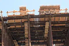 Formwork detail: The upper panels form the lowest surface of outer portion of the concrete connector, lower panels form a deck for worker access.