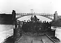 Officers, crewmen and a former prisoner of war, Lt. Frank L. Muller, USNRF, Executive Officer of USS Ticonderoga (standing third from right, wearing his uniform and a civilian cap), on the submarine's foredeck, while she was passing through the Kiel Canal on the way to Harwich, England to be surrendered, 28 November 1918.