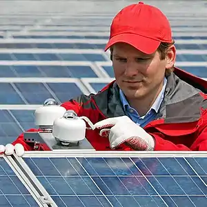 Two SR30 pyranometer positioned on a bracket, horizontally and in plane of array, next to a solar panel.