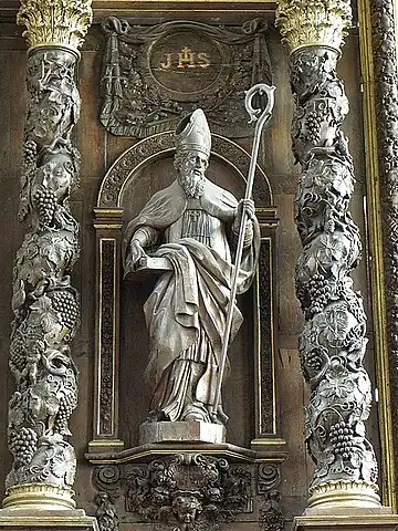 Statue to the left of the central painting depicting the visitation, thought to be Saint Augustine