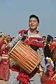 A Rai man playing traditional drum (Dhol)