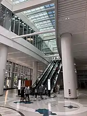 The Grand Hall, with escalators to the 3rd floor bus deck and a portion of Julie Chang's terrazzo floor, titled The Secret Garden