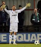 Bearded white man wearing goalkeeping gloves, pictured during a football match.