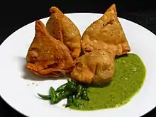 Samosa served with chutney.