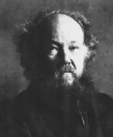 elderly white man with shaggy beard and receding hair