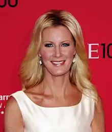 A women with blond hair, wearing a white outfit