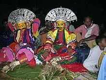 Channel/medium of Koti and Chennayya preparing himself with the makeup and tying the ornaments before the start of the Bhūta Kōlā ceremony