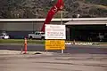 Wind sock and notices to airmen as seen by the end of Runway 22