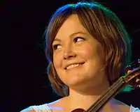 Sara Watkins holding a fiddle