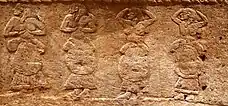 Image of a carving showing a group of four women.