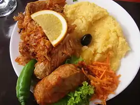 Image 11A popular Moldovan dish of sarmale (stuffed cabbage rolls), accompanied by sauerkraut and mămăligă (from Moldovan cuisine)