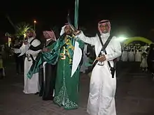 Image 26Saudi males dressed and prepared for ardah, the national dance. It also includes swords, poetry, and singing. (from Culture of Saudi Arabia)