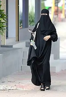 Image 1Saudi woman wearing a niqāb in Riyadh. Many women commonly wear a niqab or a burqa in Saudi Arabia. (from Culture of Saudi Arabia)