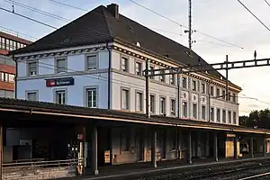 Three-story building with half-hipped roof