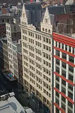 View of restored cast iron facade from an adjacent building across the street. Paint color has been changed from gray-blue to off-white.