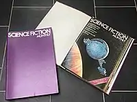 Two magazine binders, one open to show the front page of the first magazine