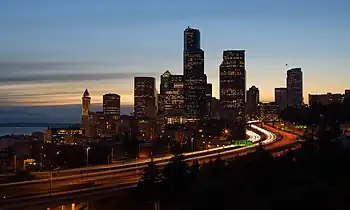 Cityscape of a busy major city backlit by an evening sky during sunset.