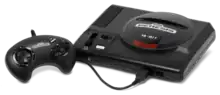 Black video game console with top-loading slot and single, wired controller with directional pad and four buttons