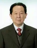 Professional headshot of a middle-aged Japanese man