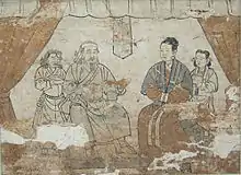 The tomb occupants are Han but are wearing Mongol-style clothing. The female tomb occupant is depicted wearing the woman's red Mongol robe under a short overjacket but does not wear the gugu hat, Shazishan Tomb Fresco, Yuan Dynasty.