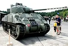 A preserved Sherman Firefly; its gun barrel is countershaded and disruptively patterned to disguise its length.