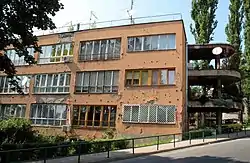 Standard facade on one of the buildings in Džidžikovac main residential complex – note bullets and artillery shell shrapnel's holes, prior recent renovation, remnants of Bosnian War.