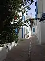 Typical street with white walls and blue window shades