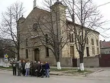 Original Project Team standing outside Synagogue building prior to construction