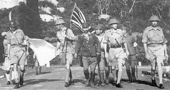 Image 39Lieutenant-General Arthur Percival, led by a Japanese officer, marches under a flag of truce to negotiate the capitulation of Allied forces in Singapore, on 15 February 1942. It was the largest surrender of British-led forces in history. (from History of Singapore)