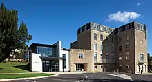 A modern building with sweeping curved walls to the entrance