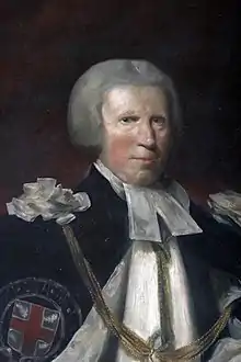 An rough oil painting portrait of an old white man with grey hair (or wig), robed as the Prelate of the Order of the Garter, with preaching bands and a blue outer cloak bearing the St George's Cross emblem of the Order.