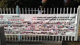 Banner with photographs depicting the missing from the conflict