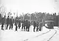 Skiers waiting for the streetcar, Rockliffe Park, c1913