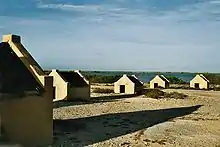 Image 16The forced African migrants brought to the Caribbean lived in inhumane conditions. Above are examples of slave huts in Dutch Bonaire. About 5 feet tall and 6 feet wide, between 2 and 3 slaves slept in these after working in nearby salt mines. (from History of the Caribbean)