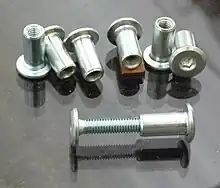 Sex bolts, one with a bolt mounted