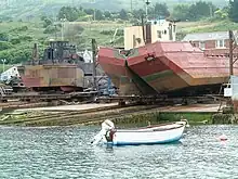 Slipway at Portland Harbour, Dorset, England, holding a split dump barge (on right)