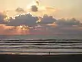 A person taking an early morning walk on the Gulf side of the island