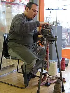 A similar old sock-knitting machine in use