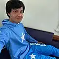 Bangladeshi boy wearing a Somali flag tracksuit.