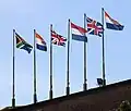 The six historical flags that have flown over the Cape, in chronological order from right to left: the Prince's Flag, the flag of Great Britain, the Batavian flag, the flag of the United Kingdom, the old South African flag, and the current South African flag