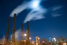 steam in the sky from the plant at night