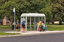 People waiting at a bus stop