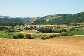 View of the town of Montaigut-le-Blanc with the village of St. Julien in the foreground and Montaigut-le-Blanc dominated by its castle on the hill in the background