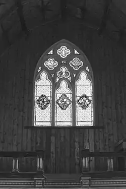 An interior view of the altar and stained glass window