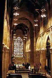 Interior view looking the length of St. Andrew's Cathedral, showing the tall arched openings of the nave, and the large Perpendicular style, seven-light east window.