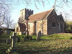 Stone building with square tower.