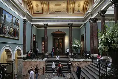 The Staircase Hall (1884–1887), designed by John Taylor, in a photograph of 2007. Cimabue's Celebrated Madonna by Frederic, Lord Leighton is visible to the left.