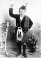 Boy wearing open necked velvet doublet, kilt and plaid (1898)